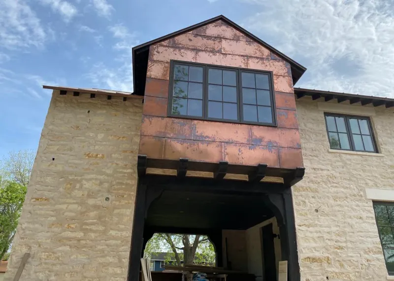 Copper metal panel facade on a stone building for Skylight Installation in Tinton Falls